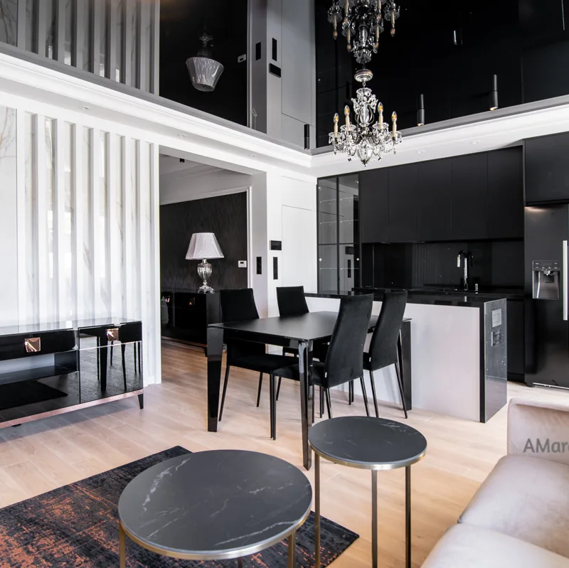 Salon z czarną komodą, ścianą w dekorze marmuru i czarną kuchnią